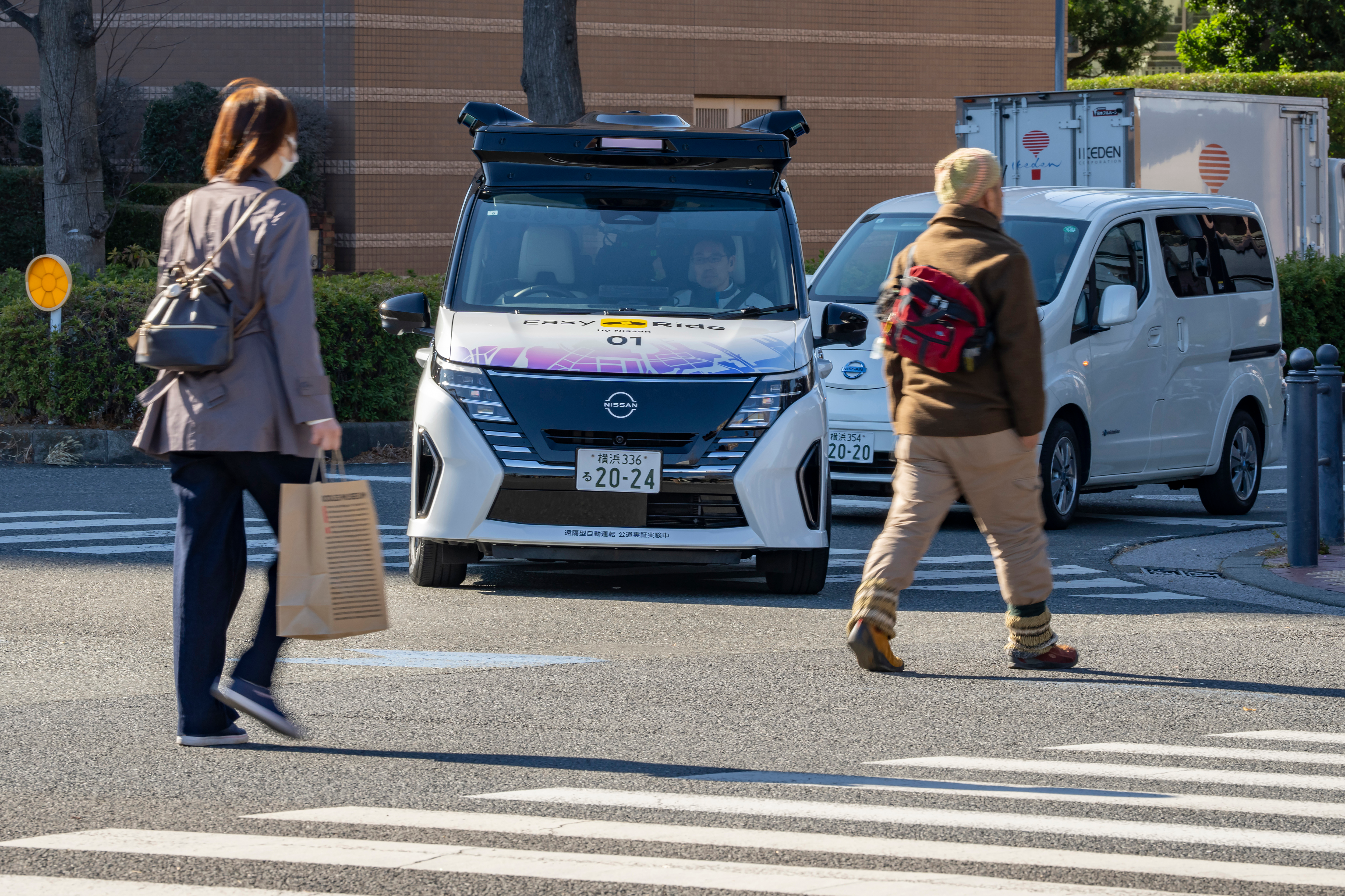 In this photo released by Nissan Motor Corp., its driverless vehicle, center, drives along a street in Yokohama, near Tokyo in February 2025.