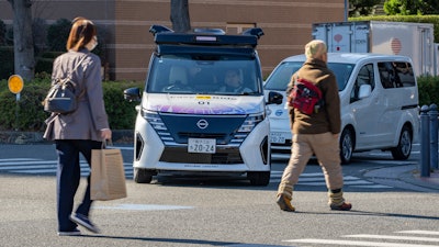 In this photo released by Nissan Motor Corp., its driverless vehicle, center, drives along a street in Yokohama, near Tokyo in February 2025.