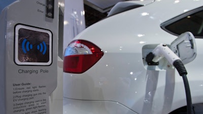 A display shows how the dual-mode electric S6DM sport utility vehicle from Chinese automaker BYD can be plugged into a charging station to recharge its onboard batteries, at the North American International Auto Show on Monday, Jan. 10, 2011, in Detroit.