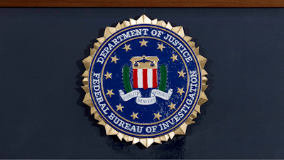 This June 14, 2018 file photo shows an FBI seal on a podium before a news conference at the agency's headquarters in Washington.