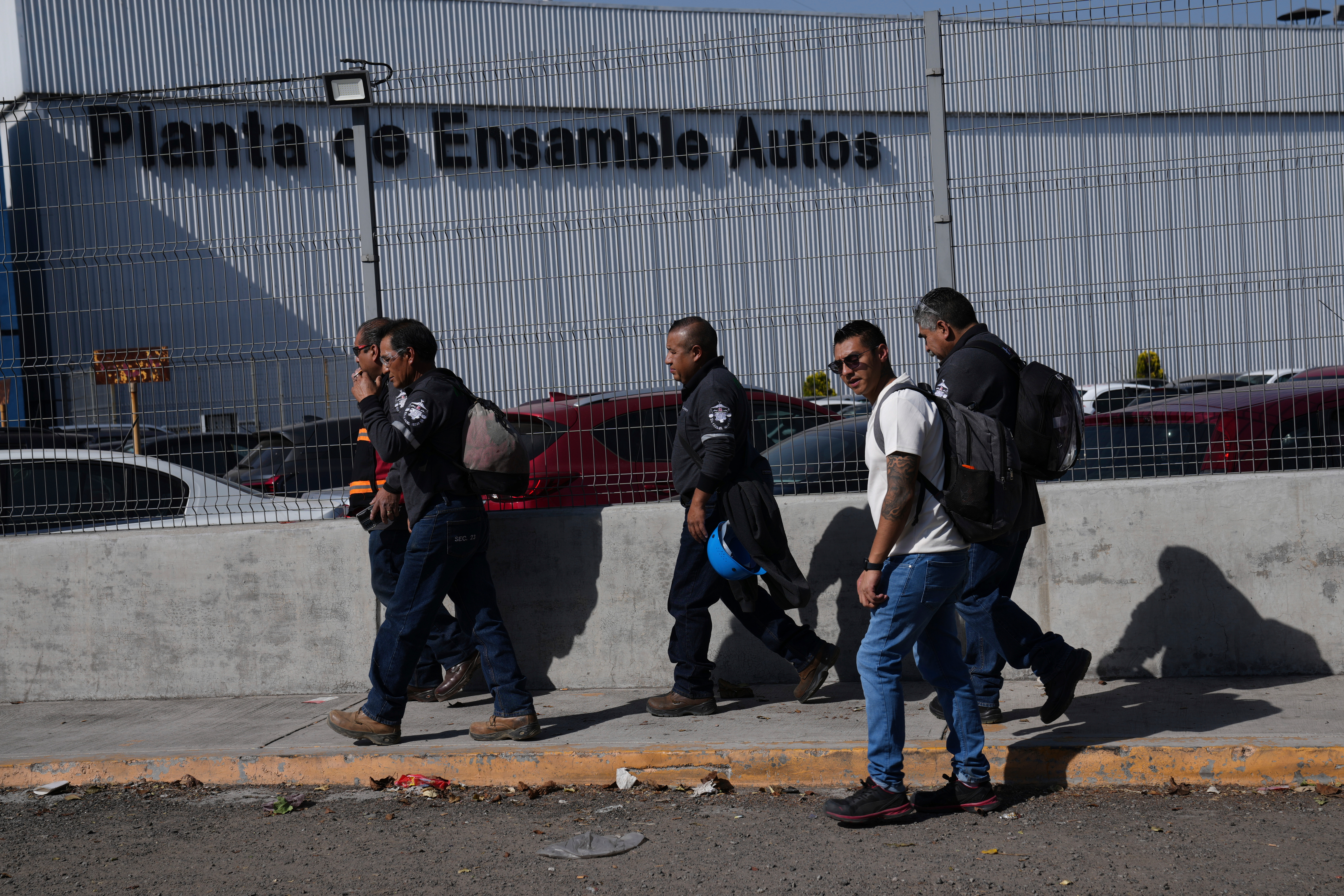 Workers arrive at the Stellantis car assembly plant in Toluca, Mexico, Thursday, April 3, 2025.