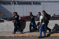 Workers arrive at the Stellantis car assembly plant in Toluca, Mexico, Thursday, April 3, 2025.