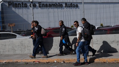 Workers arrive at the Stellantis car assembly plant in Toluca, Mexico, Thursday, April 3, 2025.