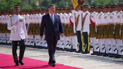 Chinese President Xi Jinping inspects honor guards during the official welcoming ceremony at the national palace in Kuala Lumpur, Malaysia, Wednesday, April 16, 2025.