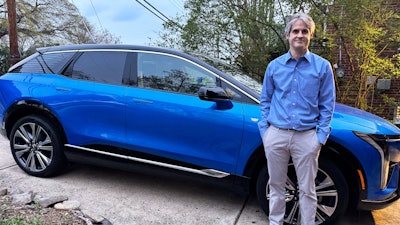 Rob Blackwell stands next to an EV he started leasing right before U.S. President Donald Trump announced expansive new import tariffs, in Richmond, Va., on April 3, 2025.