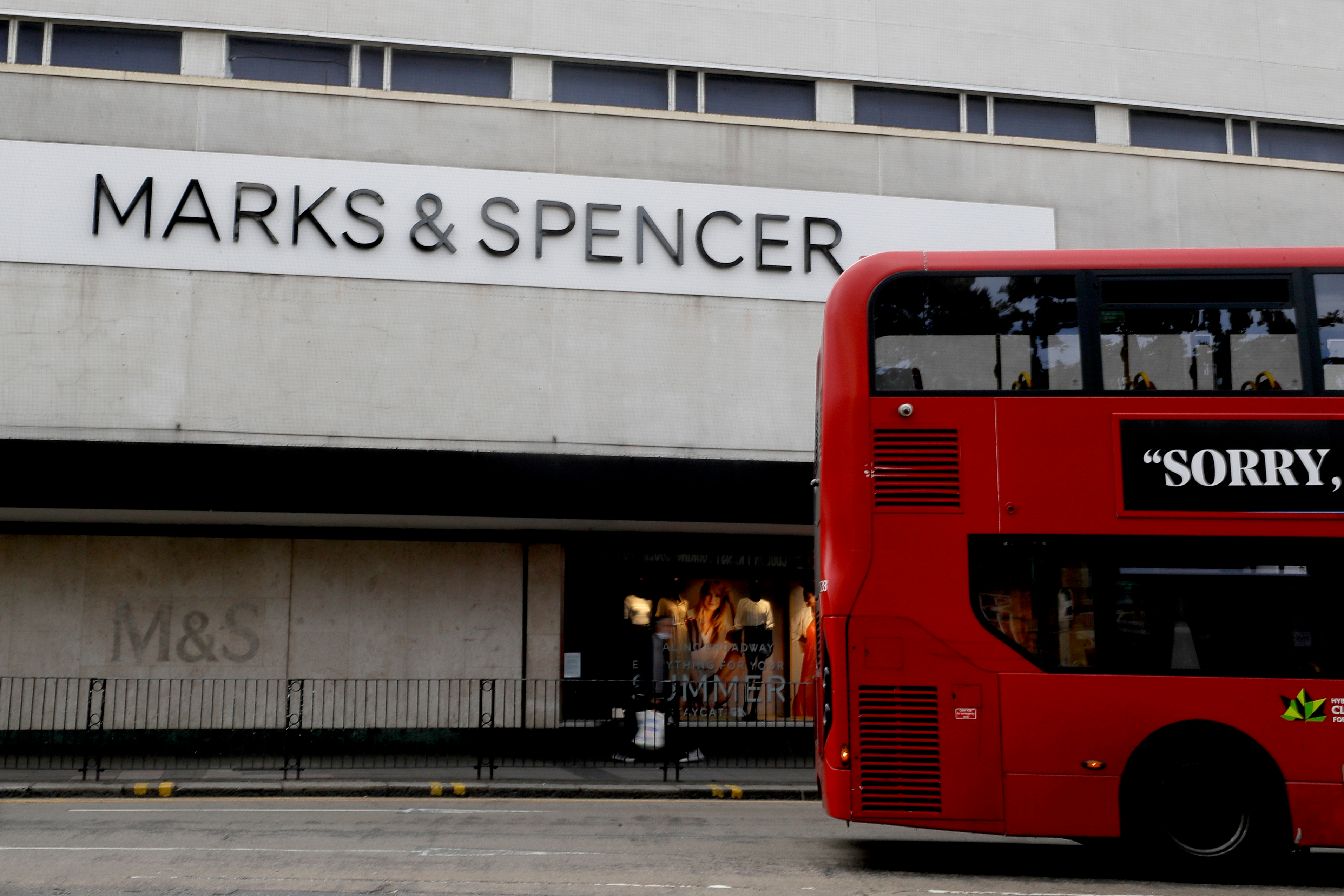 A bus passes a branch of Marks and Spencer in London, Tuesday, Aug. 18, 2020.