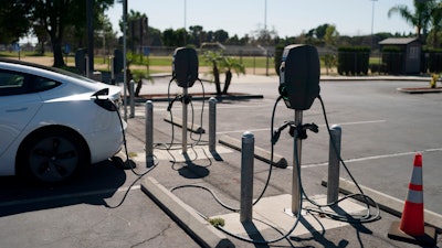 Electric vehicle chargers are seen in the parking lot of South El Monte High School in South El Monte, Calif., Aug. 26, 2022.