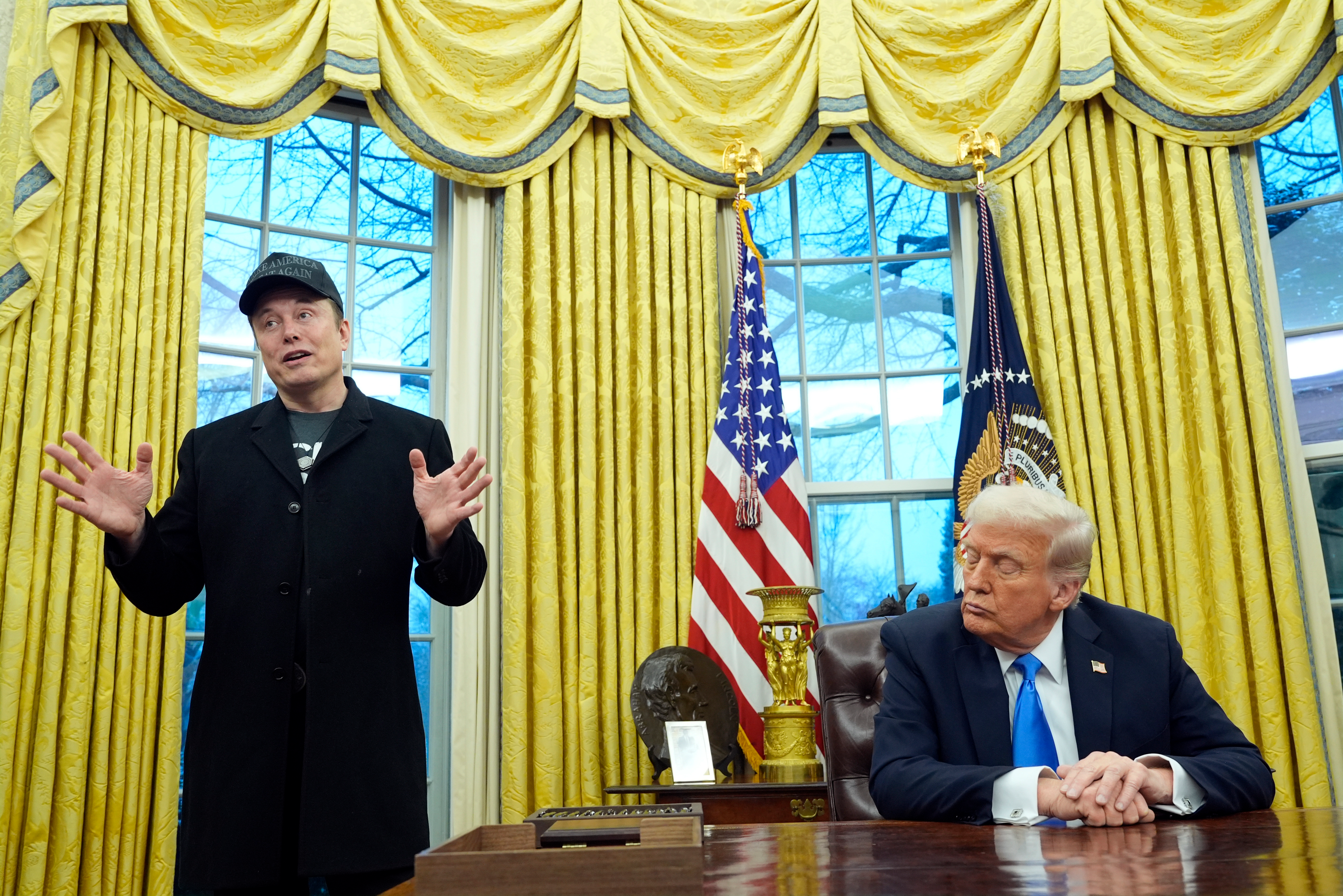 President Donald Trump listens as Elon Musk speaks in the Oval Office at the White House, Feb. 11, 2025, in Washington.