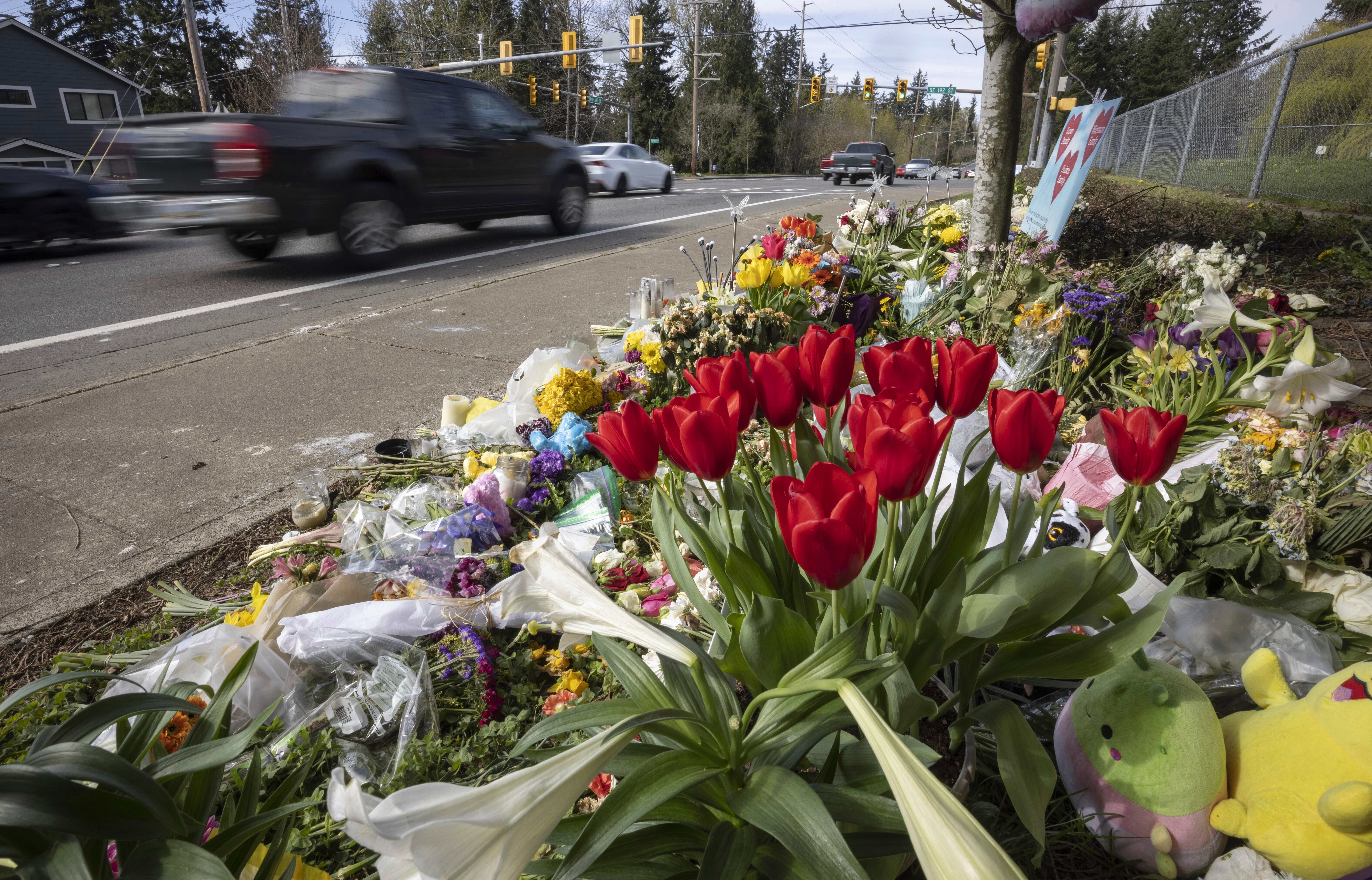 Flowers line a memorial in Renton, Wash., April 2, 2024, near where a speeding motorist crashed into a minivan, killing four people and seriously injuring two.