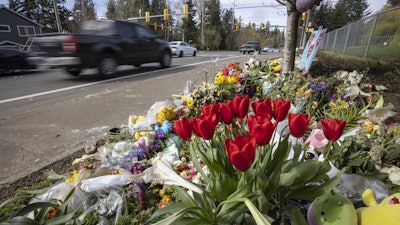 Flowers line a memorial in Renton, Wash., April 2, 2024, near where a speeding motorist crashed into a minivan, killing four people and seriously injuring two.