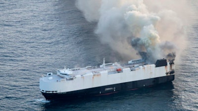 In this photo provided by the U.S. Coast Guard, smoke rises from cargo vessel Morning Midas approximately 300 miles south of Adak, Alaska, June 3, 2025, as the crew of a cargo ship carrying around 3,000 vehicles to Mexico, abandoned ship after they could not control a fire.