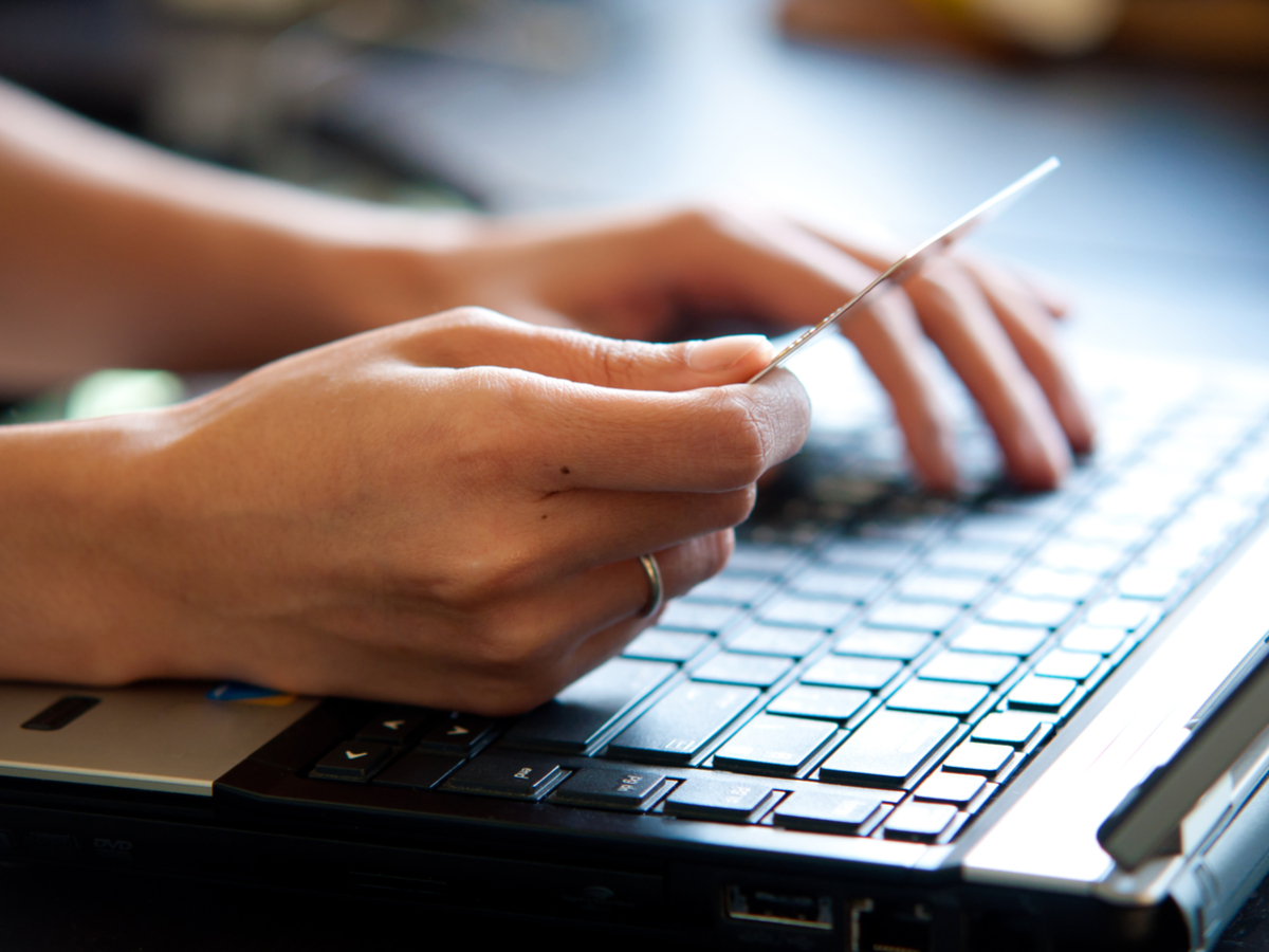 An online shopper types their credit card information on a laptop. Photo: Shutterstock.