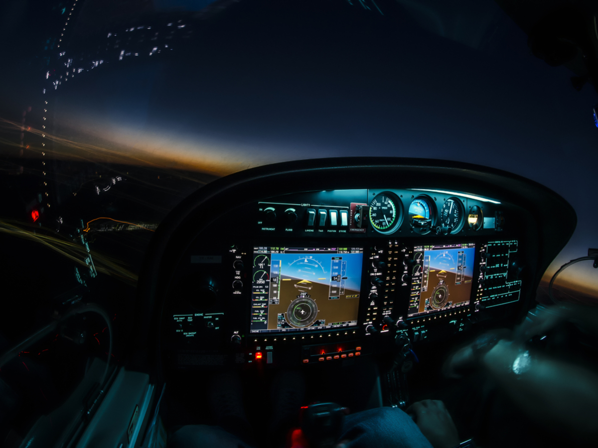 Controls are illuminated inside an aircraft cockpit at dusk. Photo: Shutterstock.