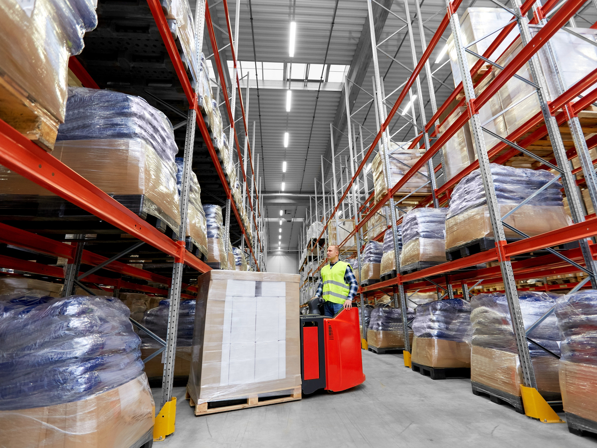 A warehouse worker operates a forklift. Photo: Shutterstock.