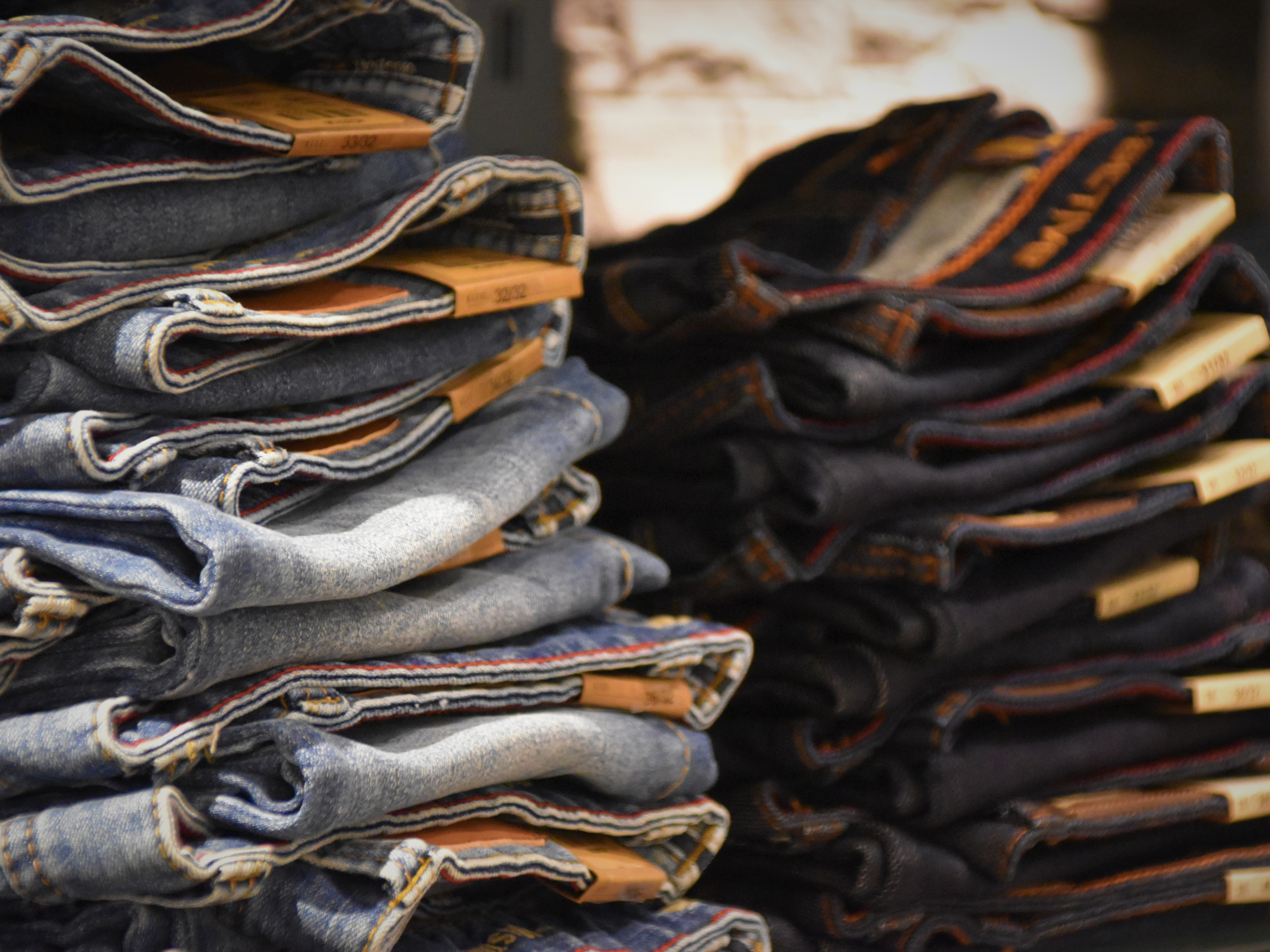 A PHOTO OF A PILE OF FOLDED JEANS