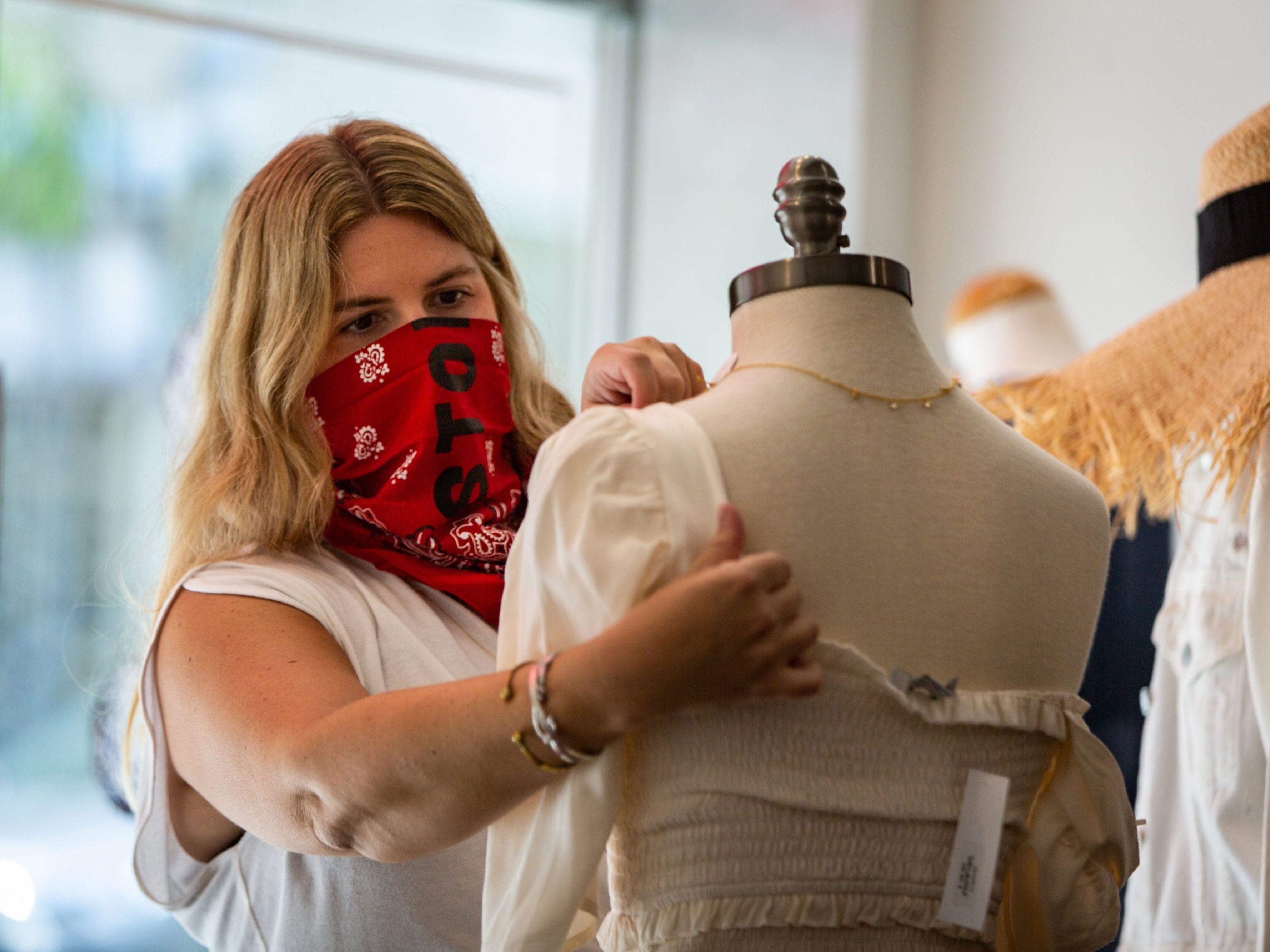 A retail employee adjusts a store mannequin. Photo: Bloomberg.