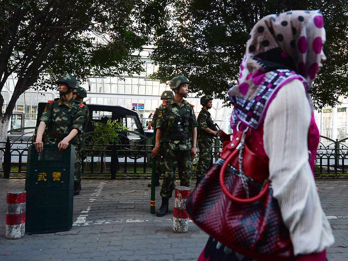 A woman walks in Xinjiang, China. Photo: Bloomberg.