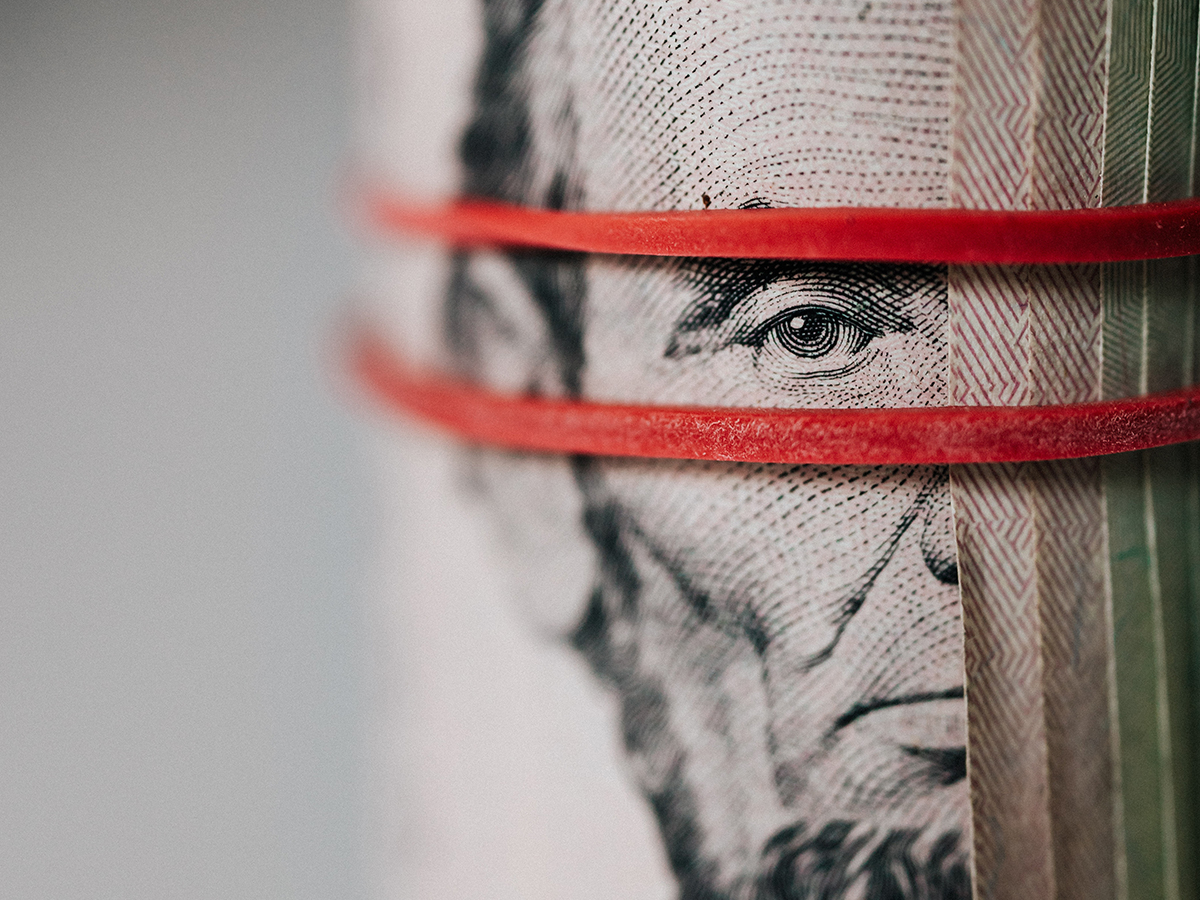 Late U.S. President Abraham Lincoln is seen on a five dollar bill. Photo: Pexels.