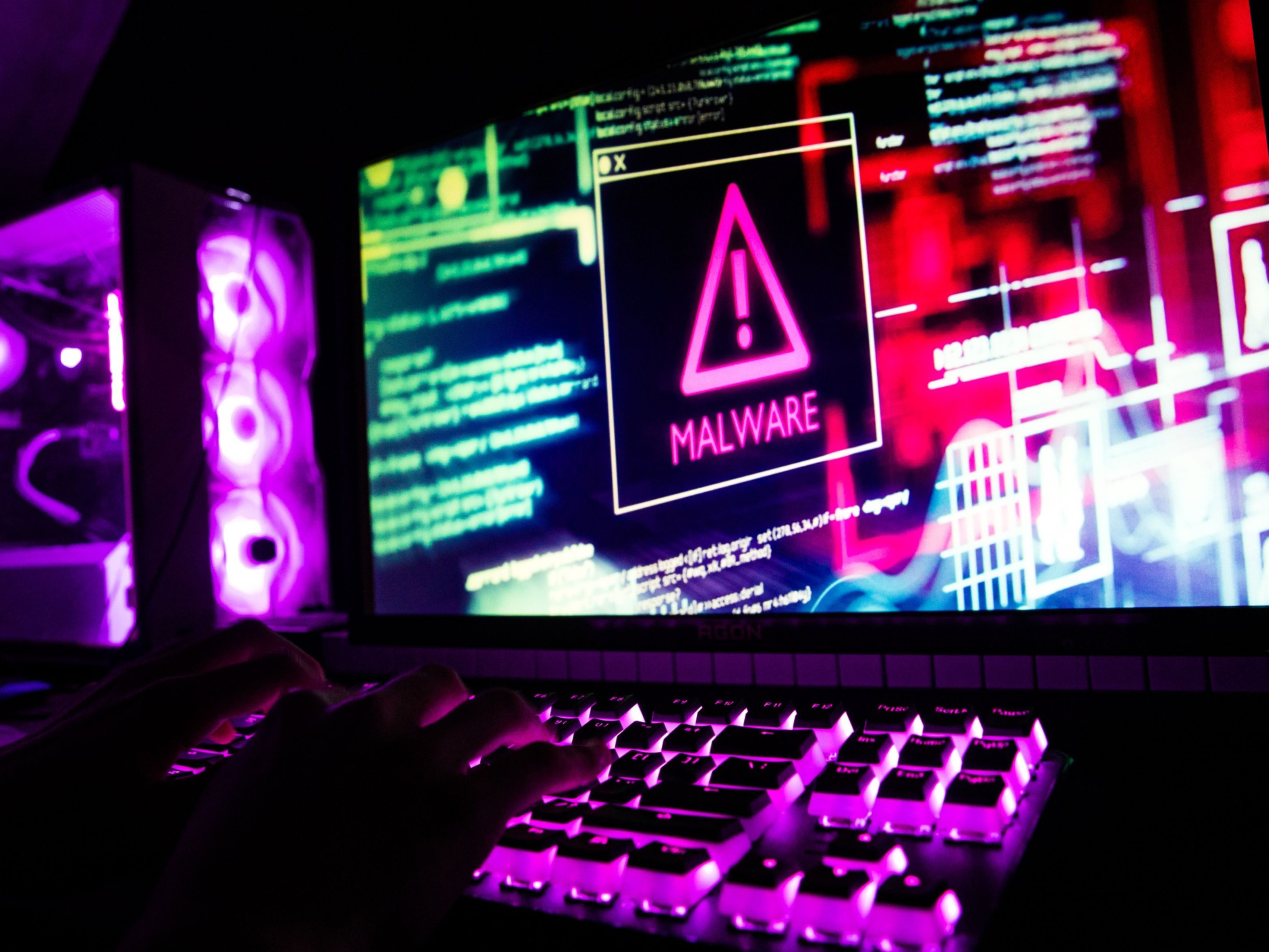 Computer code and text displayed on computer screens. Photo: Bloomberg.
