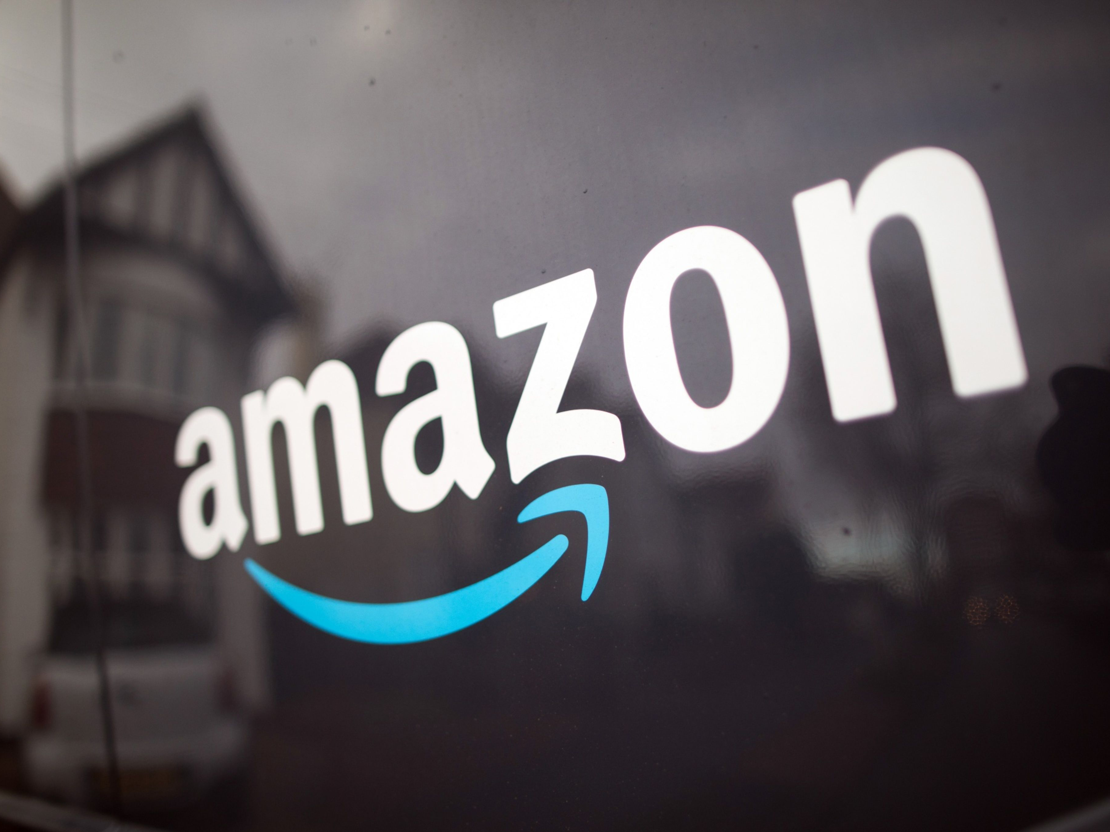 The Amazon.com Inc. company logo on the side of a delivery van. Photo: Bloomberg.