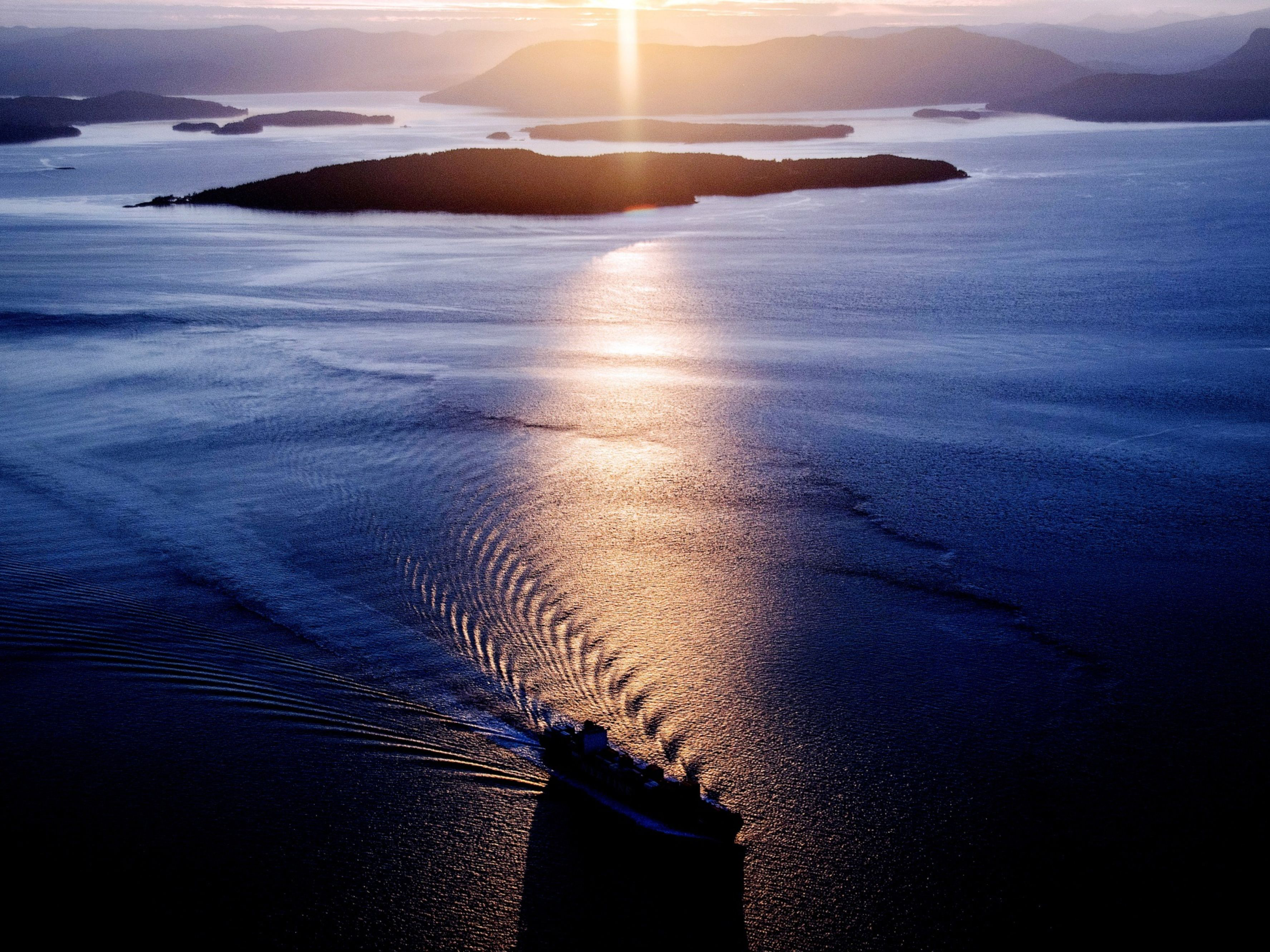 A container ship sails at dusk. Photo: Bloomberg