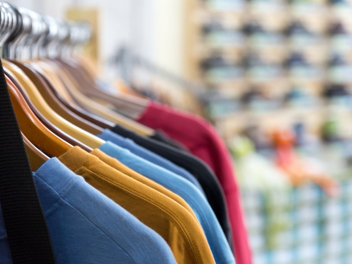 A close-up view of garments hanging in a store. Photo: Canva.