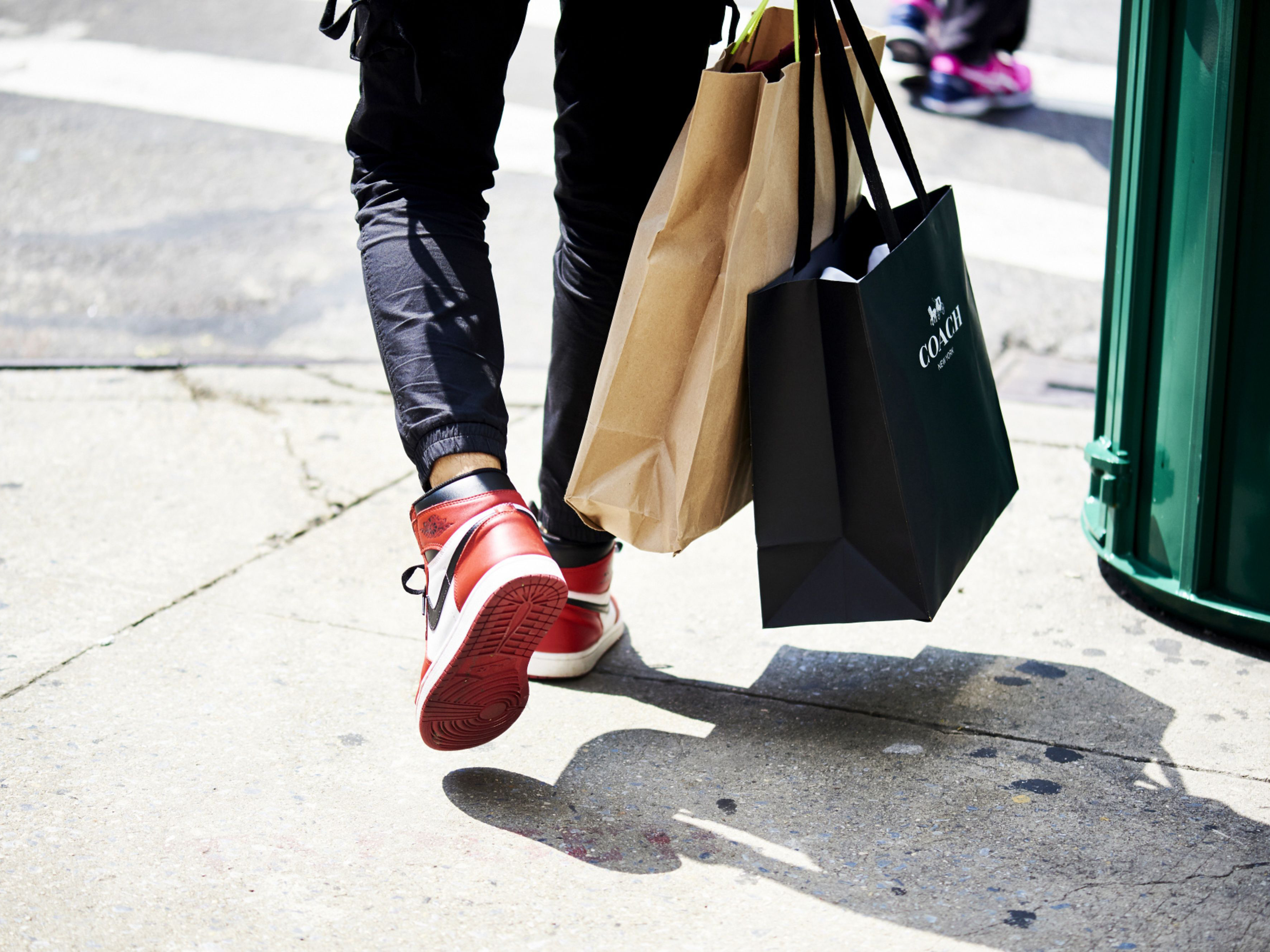 A shopper carries a Coach Inc. retail bag. Photo: Bloomberg.