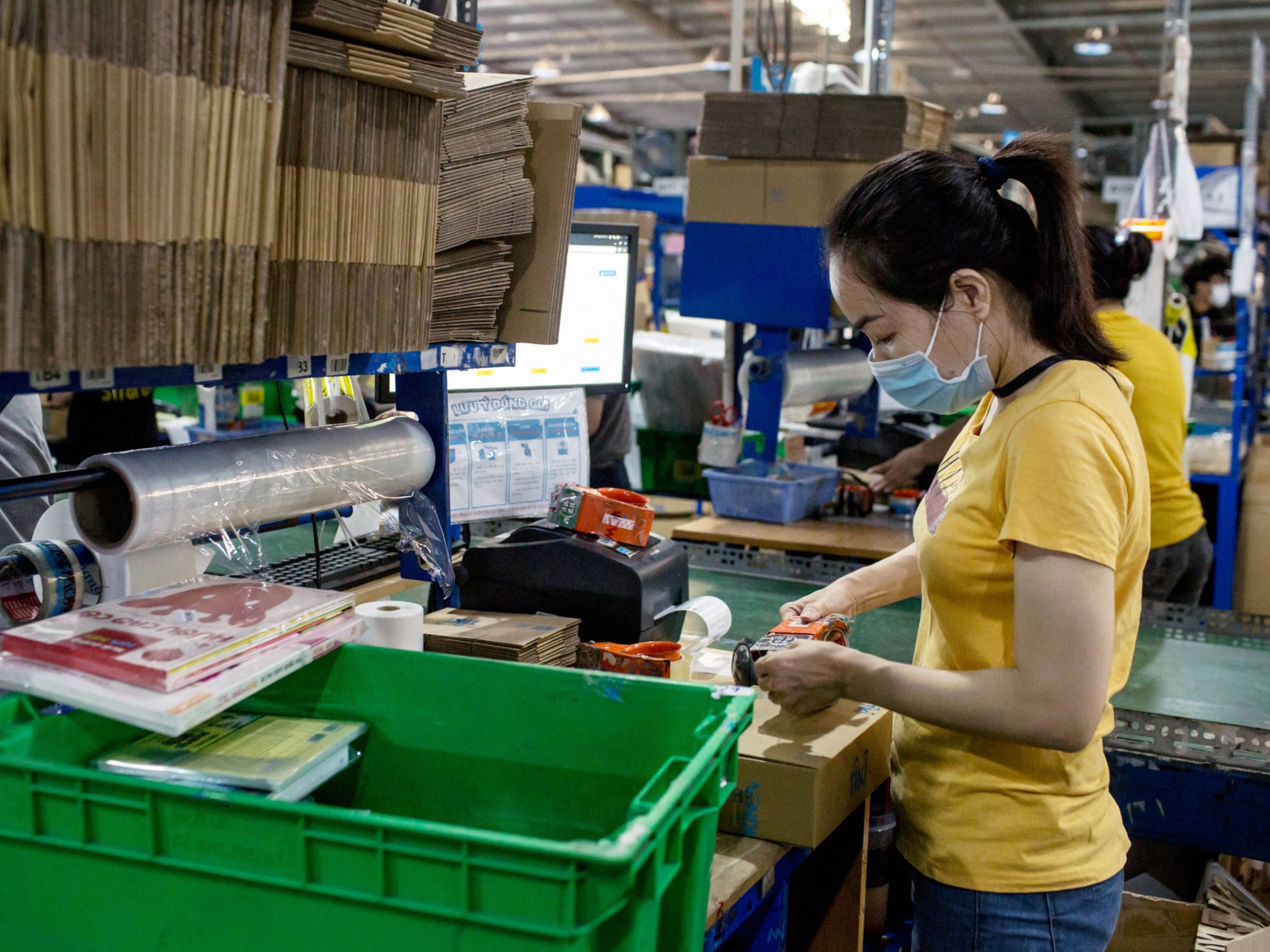 A worker packages an order at a warehouse in Ho Chi Minh City, Vietnam. Photo: Bloomberg.