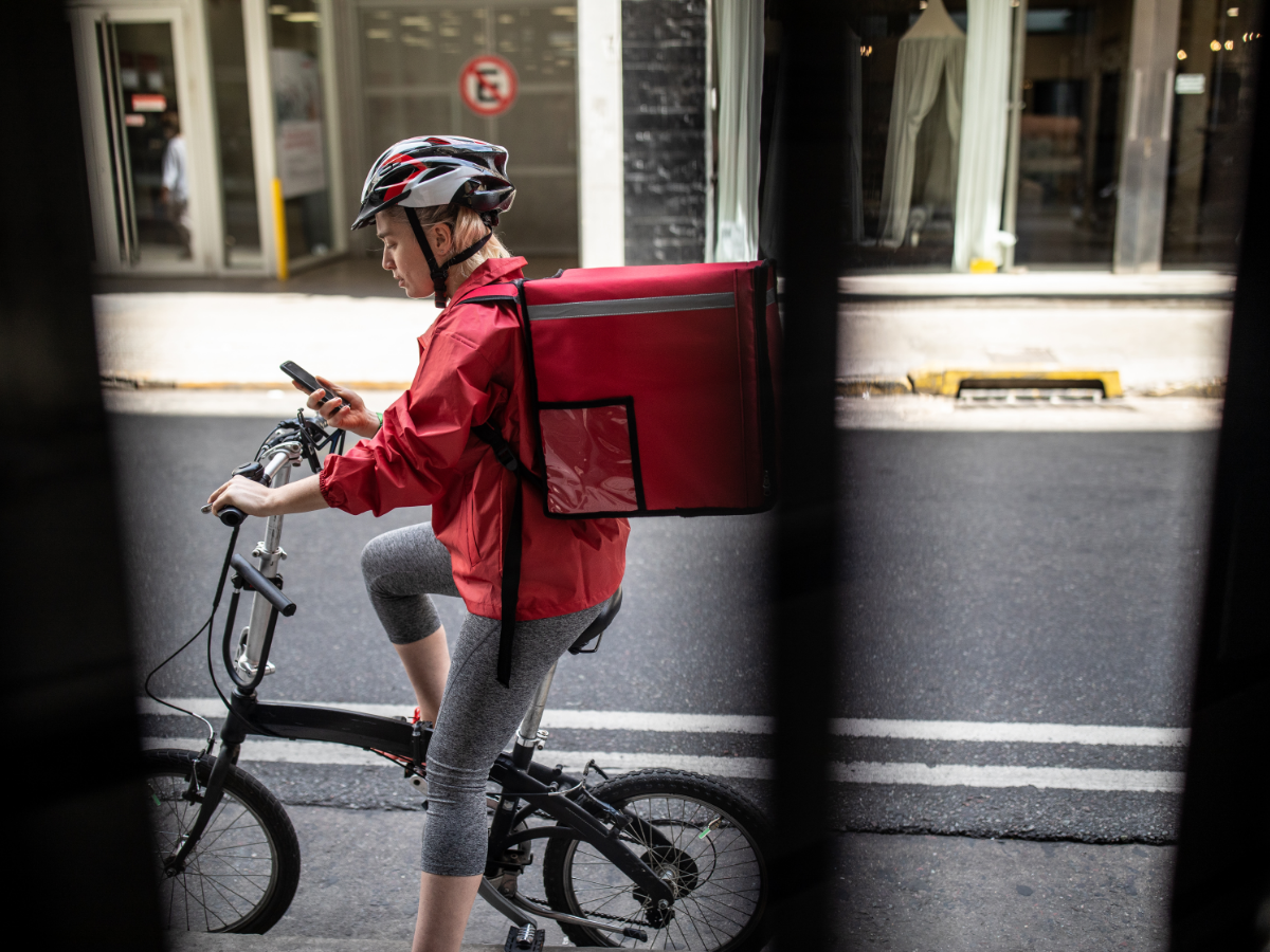 A delivery courier navigates her route. Photo: Getty Images.
