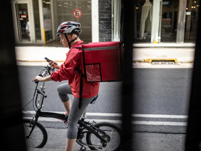 A delivery courier navigates her route. Photo: Getty Images.