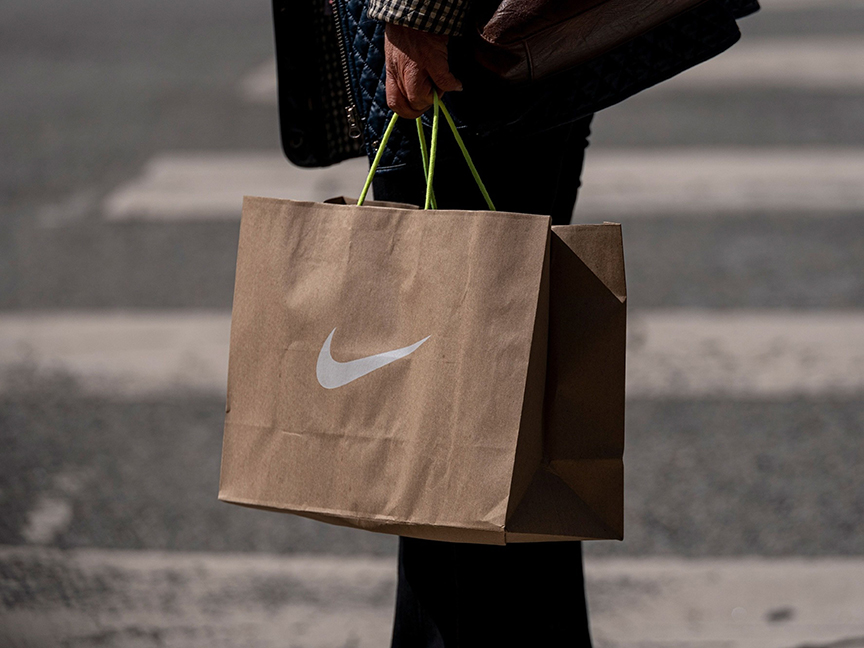 A person carries a Nike Inc. branded shopping bag. Photo: Bloomberg.