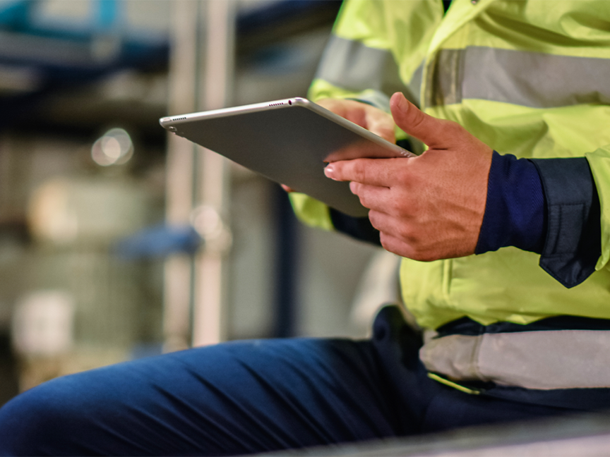 An employee views information on a digital tablet. Photo: Mungkhood Studio/ Canva.