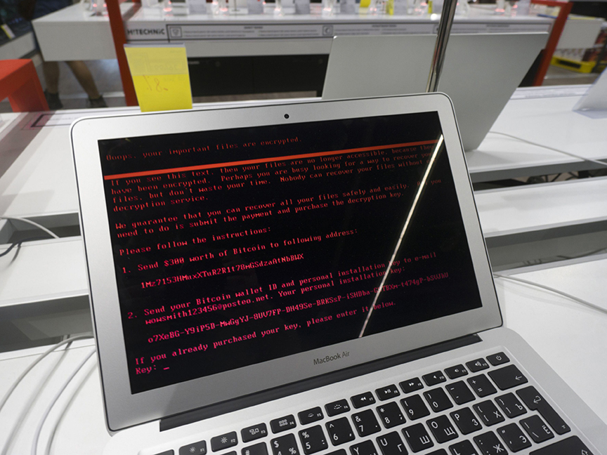 A ransomware demand for $300 worth of bitcoin is displayed on the screen of a laptop infected by the 'Petya' computer virus. Photo: Bloomberg.