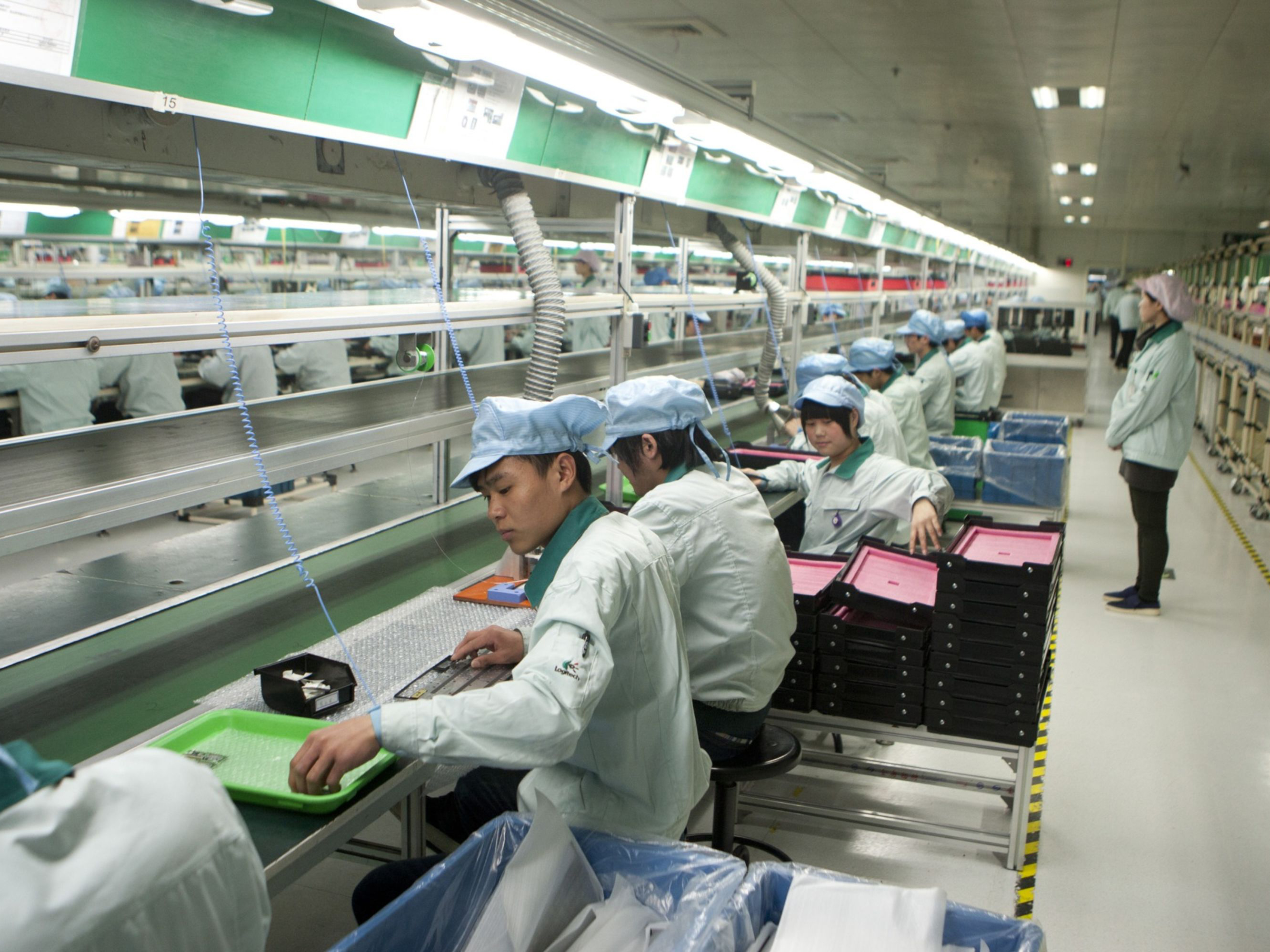 Workers assemble products at the Logitech International SA factory in Suzhou, Jiangsu Province, China. Photo: Bloomberg.