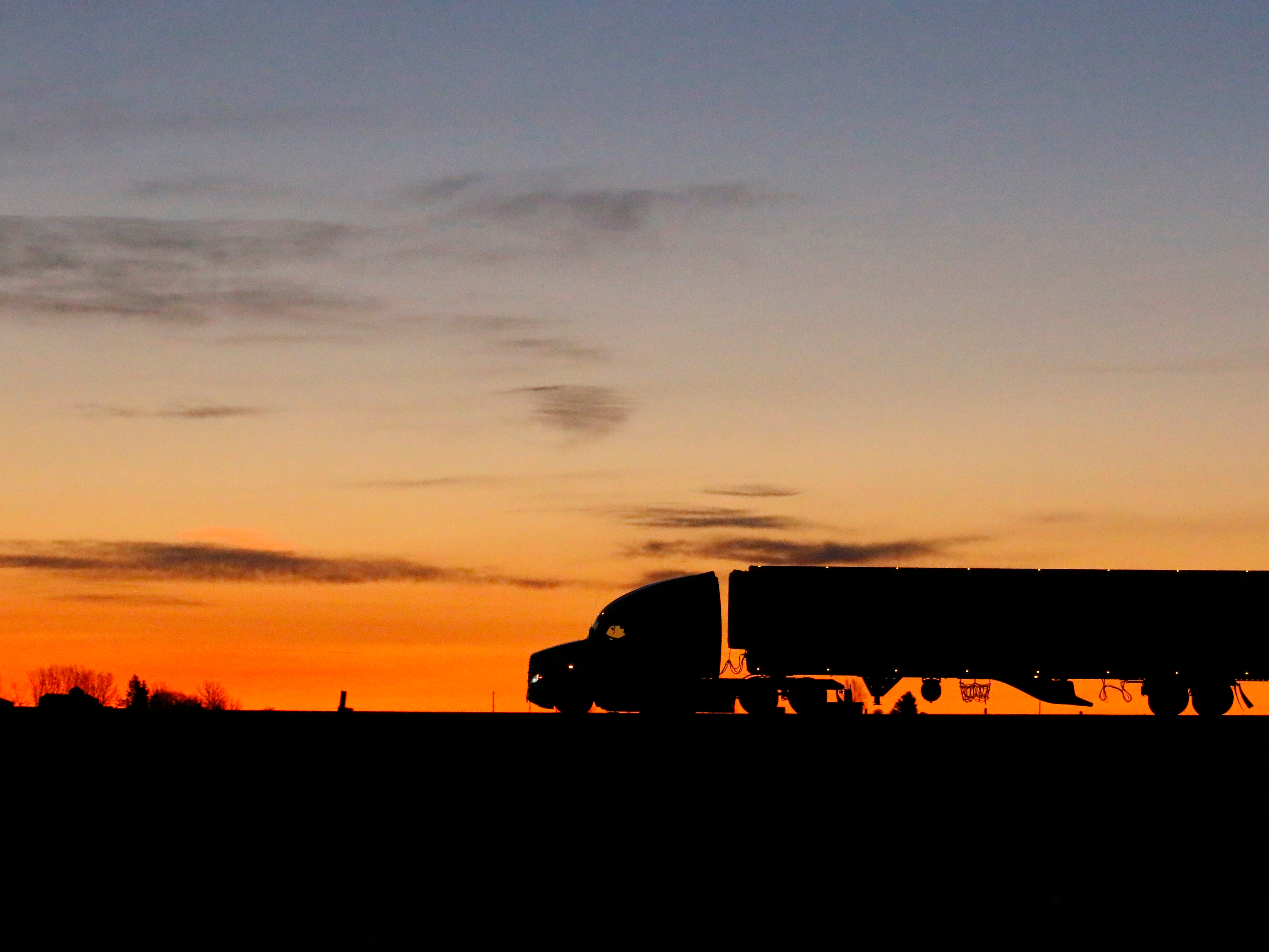 A freight truck drives at sunrise. Photo: Getty Images.
