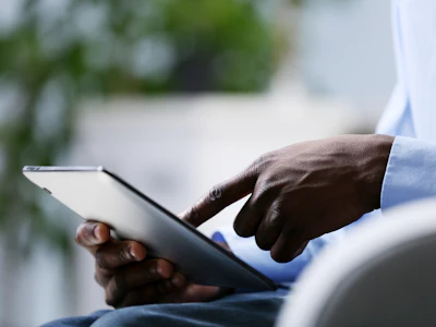 A professional views information on a digital tablet. Photo: Shutterstock.