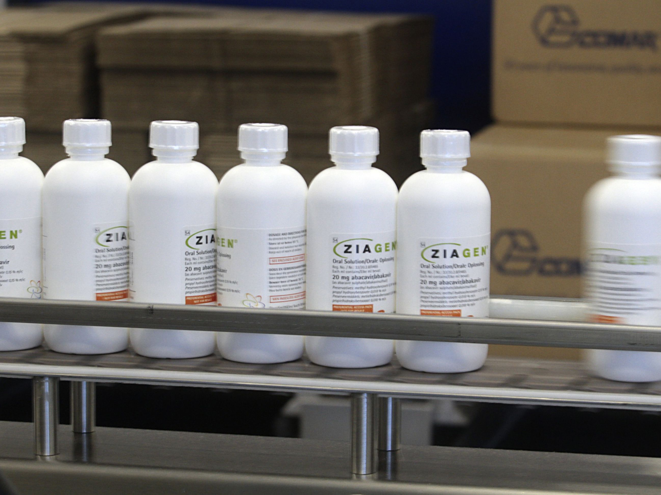 Bottles of Ziagen, an HIV oral liquid medication, move down the packaging line. Photo: Bloomberg.