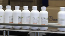 Bottles of Ziagen, an HIV oral liquid medication, move down the packaging line. Photo: Bloomberg.