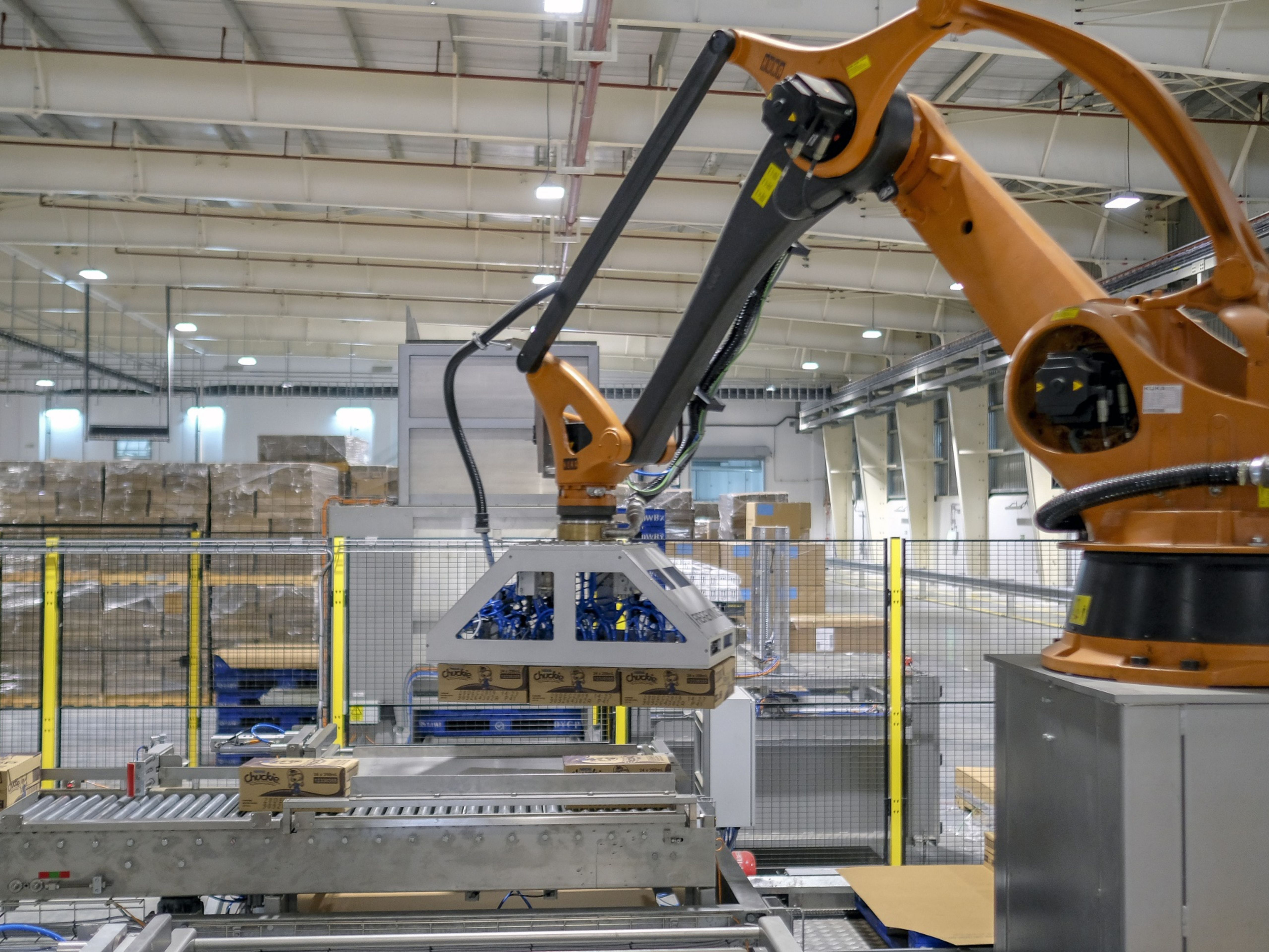 A robotic arm lifts boxes at a Nestle SA factory in Batangas province, the Philippines. Photo: Bloomberg.