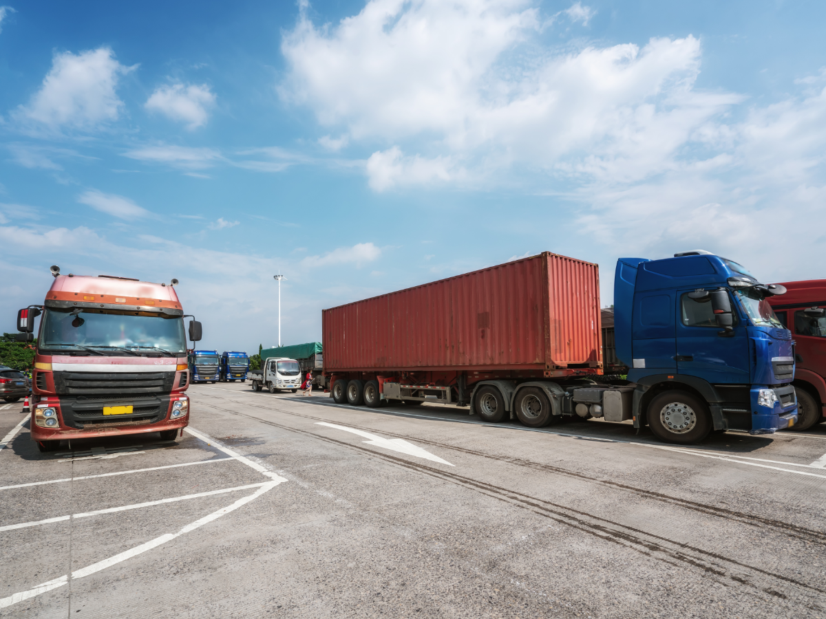 Container trucks sit in a parking lot. Photo: Getty Images.