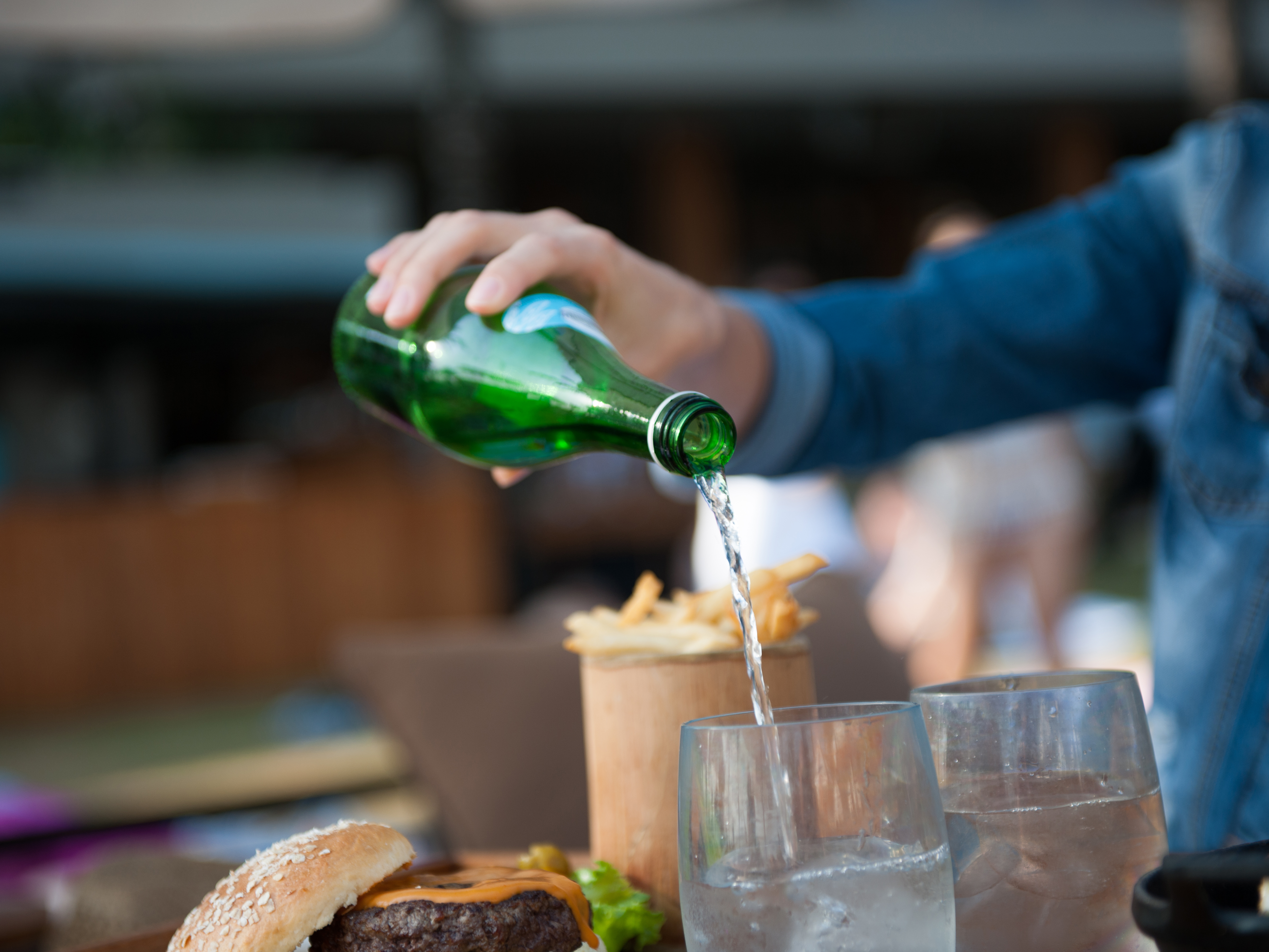 A diner pours water into a glass. Photo: Getty Images.