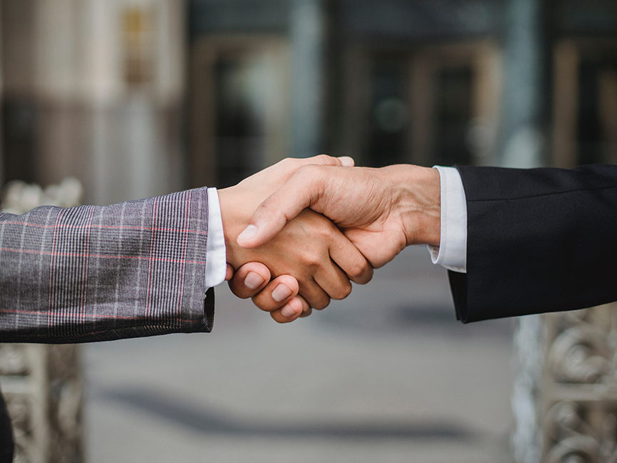 Two business professionals shake hands. Photo: Ketut Subiyanto/ Pexels.