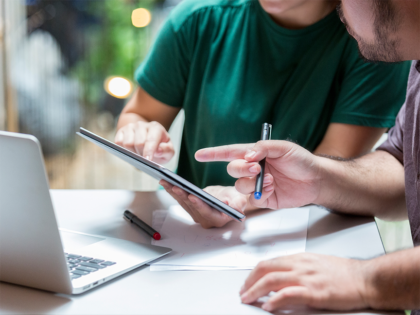 Two professionals collaborate on a project. Photo: Getty Images.