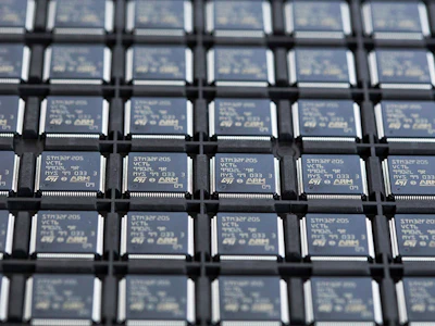 STMicroelectronics STM32F205 integrated circuit microchips (IC's) in a storage tray. Photo: Bloomberg.