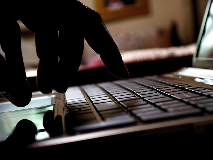 A person types at a keyboard. Photo: Getty Images.