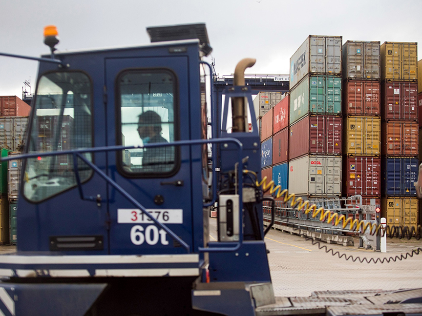 A truck passes shipping containers on the dockside at the Port of Felixstowe Ltd. in Felixstowe, U.K. Photo: Bloomberg.