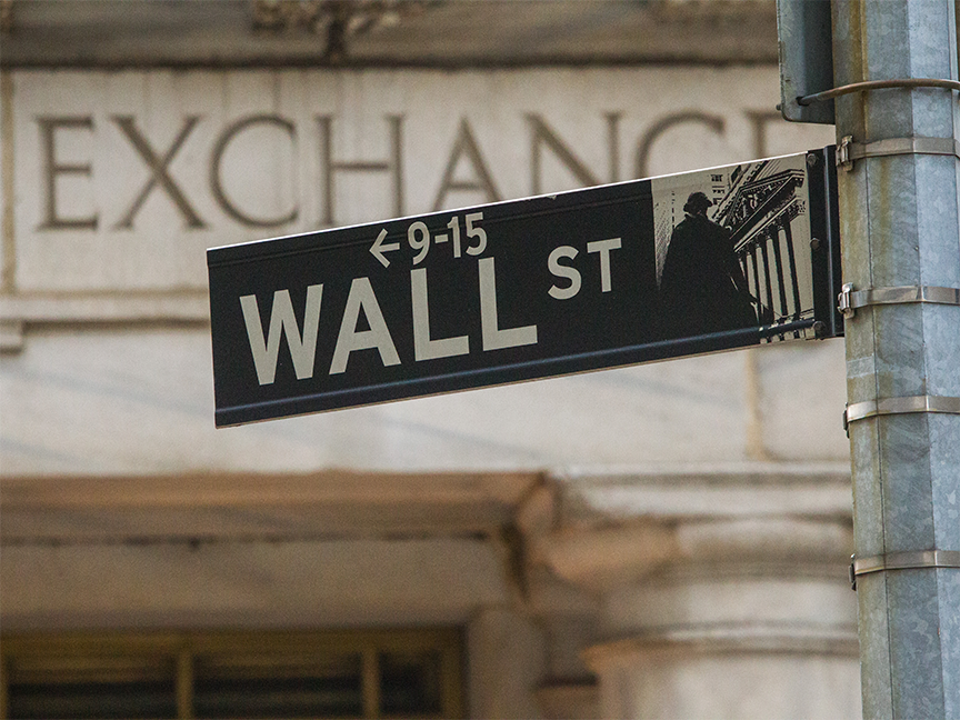 A Wall Street sign stands in front of the New York Stock Exchange (NYSE) Building in New York. Photo: Getty Images.