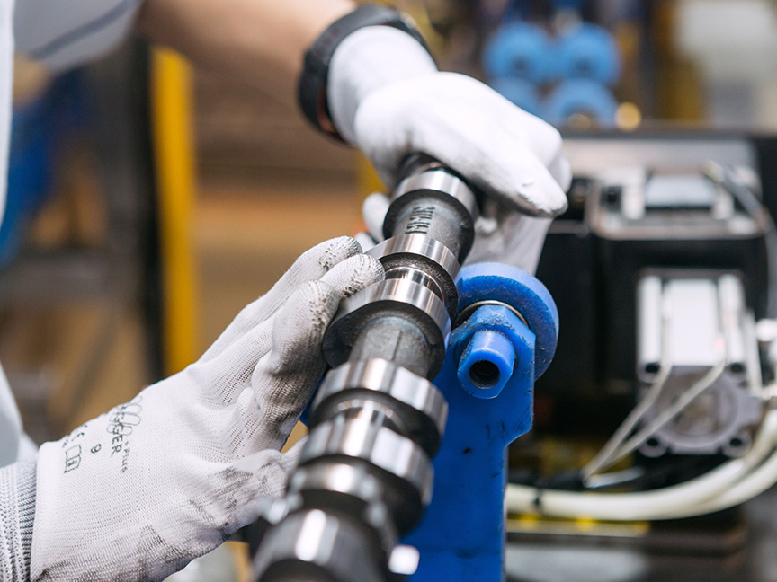 An employee performs a quality check on an engine part at a Toyota Motor Corp. manufacturing facility. Photo: Bloomberg.
