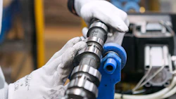 An employee performs a quality check on an engine part at a Toyota Motor Corp. manufacturing facility. Photo: Bloomberg.