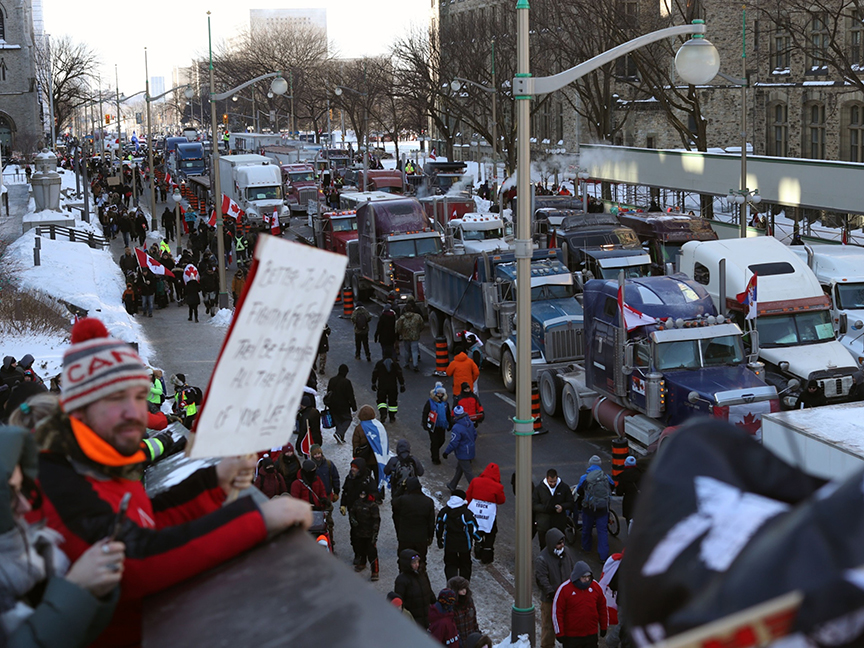 Demonstrators gather as rows of trucks sit parked during a protest near Parliament Hill in Ottawa, Ontario, Canada. Photo: Bloomberg.